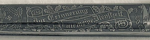 Short – Single Etch – Luftwaffe Gulls Pattern

This short variety produced by Carl Eickhorn having the 1935 – 1941 trademark has the hard to find Luftwaffe Gulls Pattern. This pattern features two Gulls flying away from the viewer within a wreath of acorns and oak leaves at the tip end, the Remembrance Motto in a ribbon centered and a closed winged National Eagle closest to the ricasso. See Pictures. 


The condition of this example is certainly NMINT or MINT as there is no wear to the blade or hilt areas. All the plating is present and no runner marks can be seen. See pictures.
As stated in The Addendum it is my opinion that this Luftwaffe Gulls pattern (among others) were being produced in advance of a newer catalog perhaps 1940. There were very few of the Luftwaffe Gulls pattern produced and perhaps only a limited quantity sold within the Carl Eickhorn Company accounting for their rarity among collectors today.
This is a beautiful etched dress bayonet with a very hard to find Luftwaffe pattern missing from most collections. 
Comes with: Black Scabbard
Certificate of Authenticity from Wayne H. Techet
Price: $2200.00 + Shipping
You’re Holding a Piece of History
#A3CEYZ