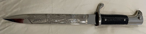 Short – Single Etch – Luftwaffe Gulls Pattern

This short variety produced by Carl Eickhorn having the 1935 – 1941 trademark has the hard to find Luftwaffe Gulls Pattern. This pattern features two Gulls flying away from the viewer within a wreath of acorns and oak leaves at the tip end, the Remembrance Motto in a ribbon centered and a closed winged National Eagle closest to the ricasso. See Pictures. 


The condition of this example is certainly NMINT or MINT as there is no wear to the blade or hilt areas. All the plating is present and no runner marks can be seen. See pictures.
As stated in The Addendum it is my opinion that this Luftwaffe Gulls pattern (among others) were being produced in advance of a newer catalog perhaps 1940. There were very few of the Luftwaffe Gulls pattern produced and perhaps only a limited quantity sold within the Carl Eickhorn Company accounting for their rarity among collectors today.
This is a beautiful etched dress bayonet with a very hard to find Luftwaffe pattern missing from most collections. 
Comes with: Black Scabbard
Certificate of Authenticity from Wayne H. Techet
Price: $2200.00 + Shipping
You’re Holding a Piece of History
#A3CEYZ
